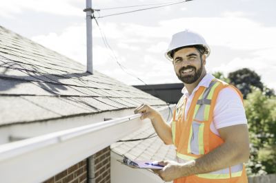 Roofing professionals inspecting a roof