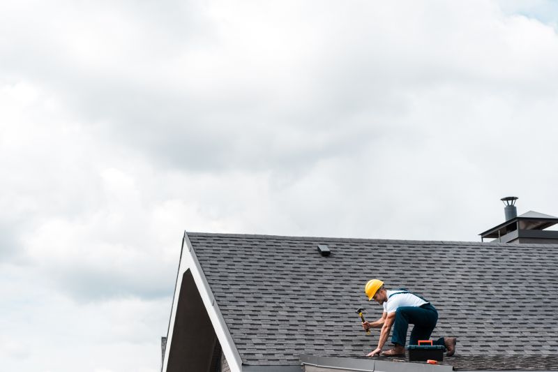 Roofing team installing new shingles